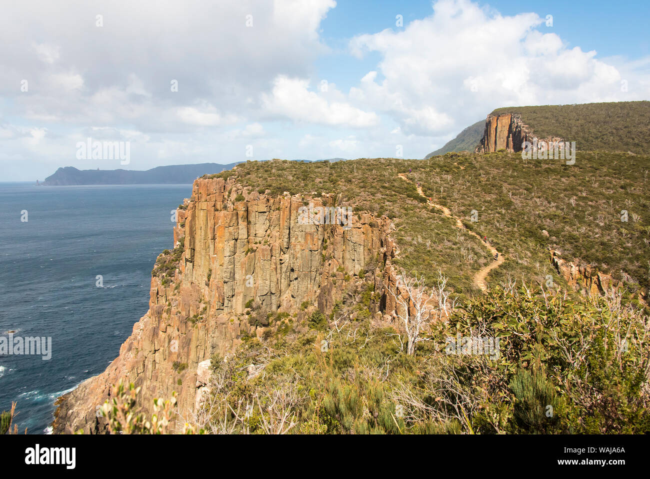 Australia, Tasmania. Hikers on Cape Hauy Track. Dolerite columns. Munro Bight, Cape Pillar Stock