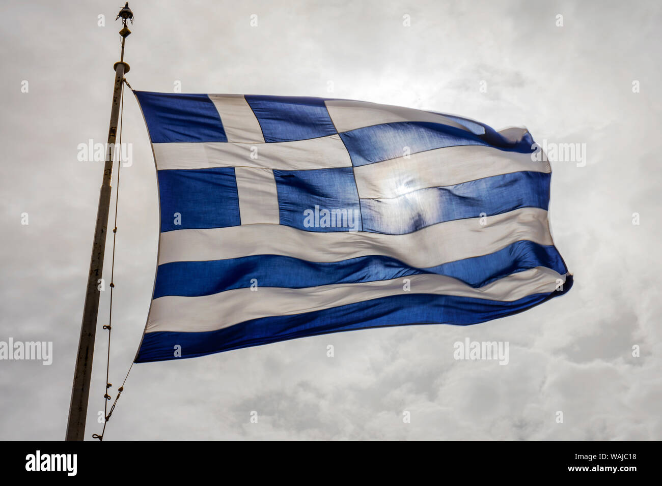 Blue and white Greek flag. Acropolis, Athens, Greece. Cross symbolizes Greek Orthodox Christianity, the religion of Greece. Stock Photo
