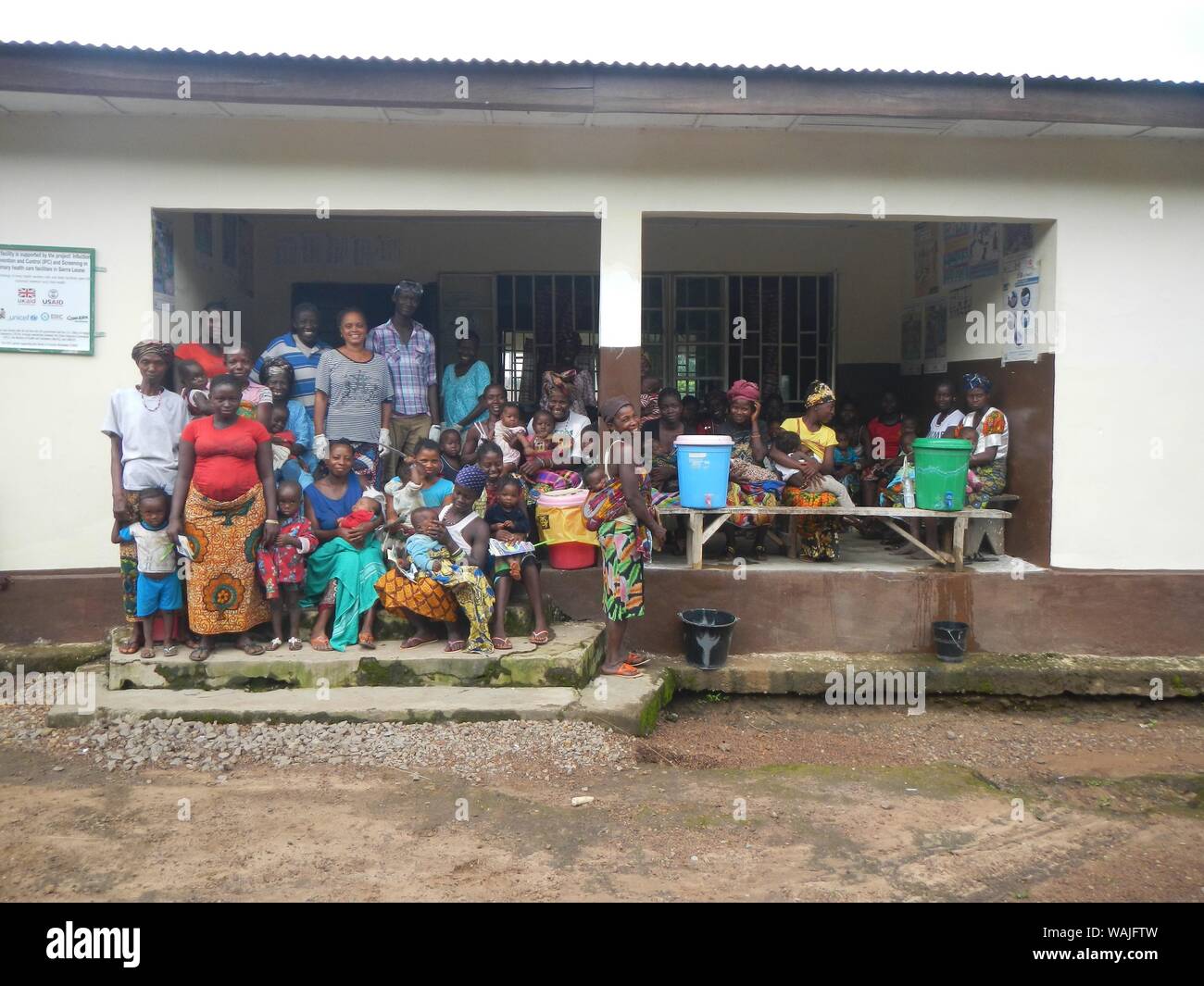 2015 - After a visit by a Centers for Disease Control and Prevention (CDC) Ebola Response Infection Prevention and Control team (IPC), both villagers and staff gathered for a group picture, which took place at a rural clinic in the Tonkolili district of Sierra Leone, August 10, 2015 Stock Photo