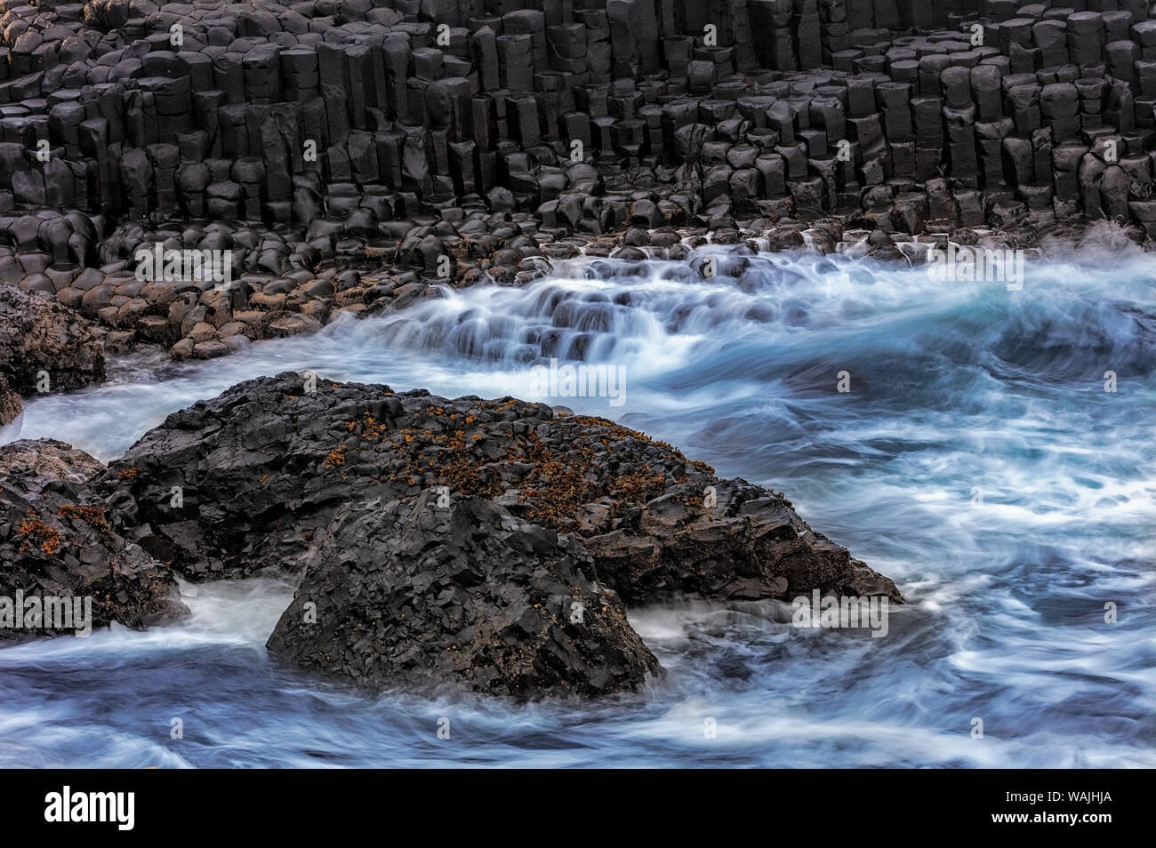 Waves crash into basalt at the Giant's Causeway in County Antrim, Northern Ireland Stock Photo