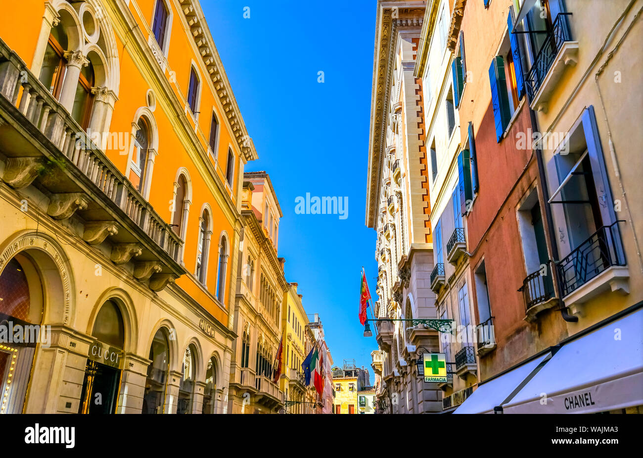 Colorful sunny main shopping street with shops and restaurants, Venice, Italy. Stock Photo