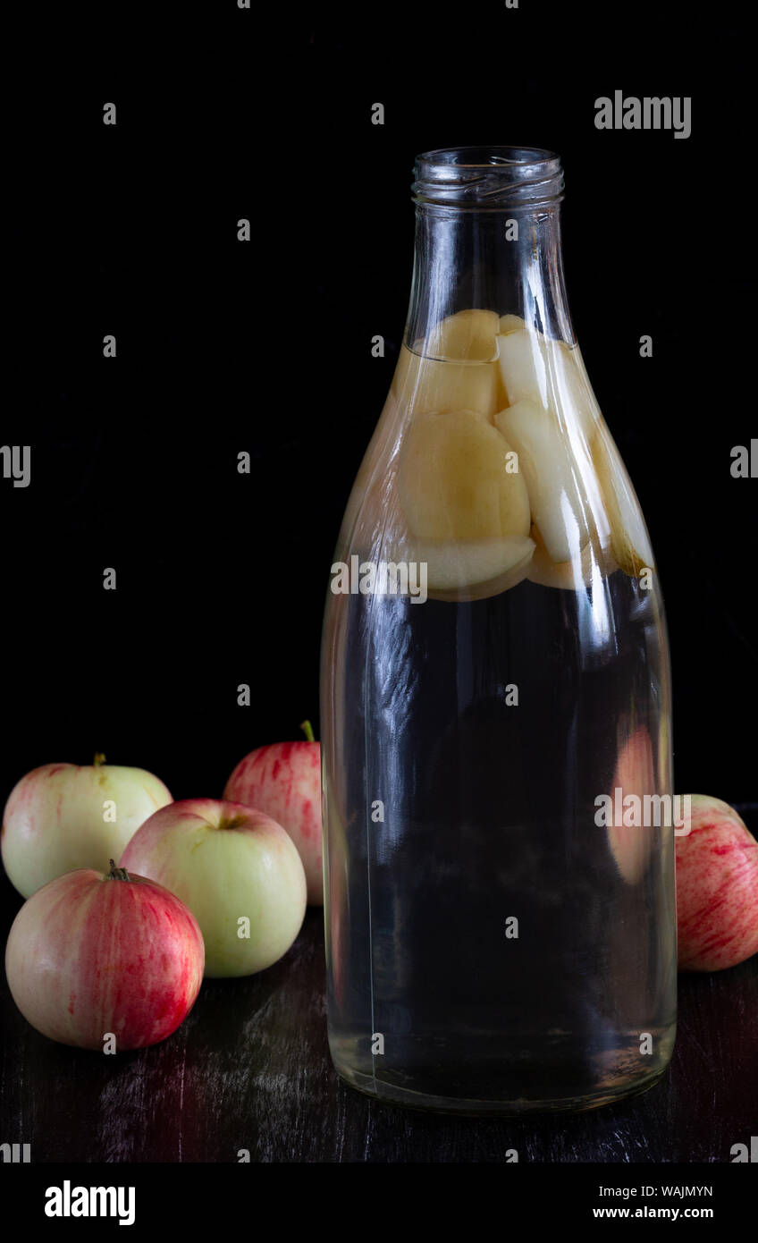 Apple kompot in glass bottle on black background Stock Photo - Alamy