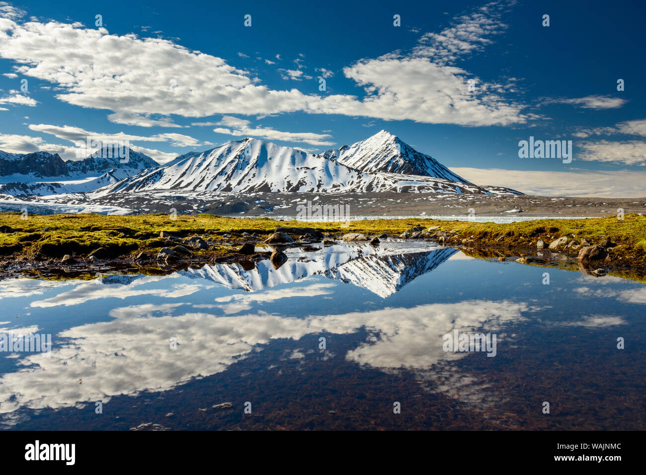 Norway, Svalbard, Spitsbergen. 14th July Glacier, mountain and cloud reflections. Stock Photo