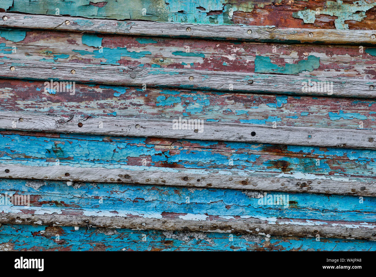 Old wooden fishing boat out of water, detail of paint. Crescent City, California. Stock Photo