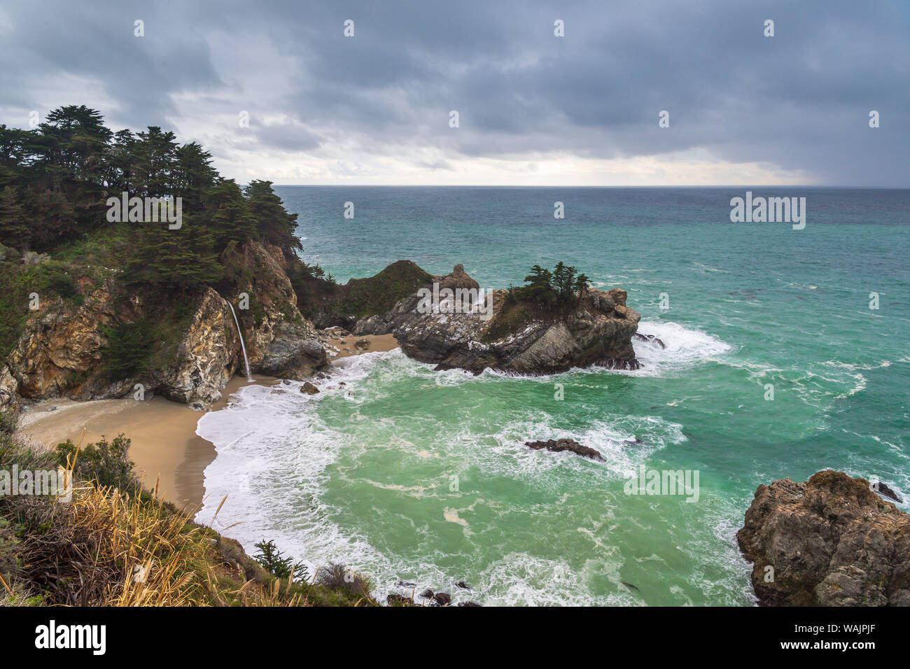 Cove with the Pacific Ocean and McWay Falls in Big Sur Stock Photo