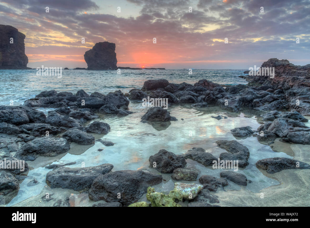 View from beach at Manele Bay of Puu Pehe (Sweetheart Rock) at sunrise, South Shore of Lanai Island, Hawaii, USA Stock Photo