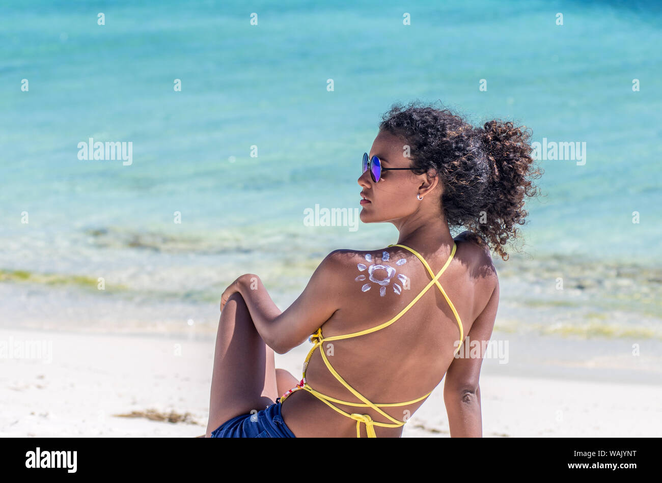 Latin With Lotion At The Beach Form Of The Sun Stock Photo - Alamy