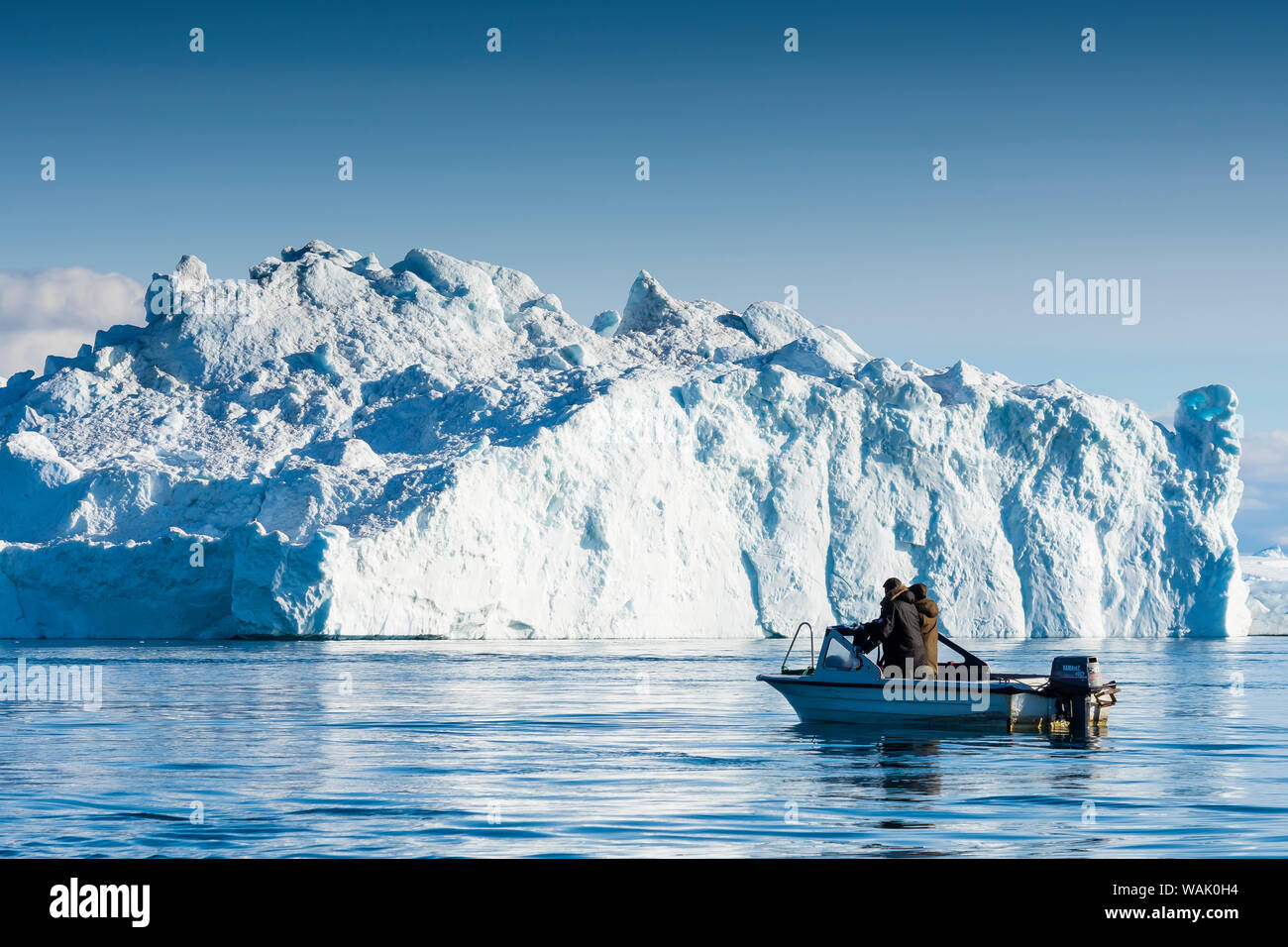 Greenland, Ilulissat. Locals fishing among the icebergs in the Icefjord. Stock Photo