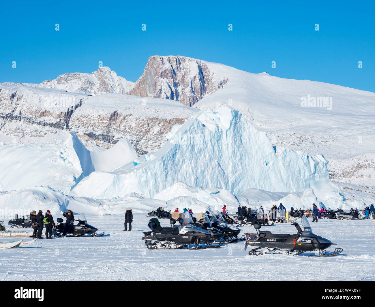Sled dog race on frozen fjord, Saatut near Uummannaq. Spectators are arriving by dog sled or snowmobile. Qualifier for the Greenland Championships 2018. (Editorial Use Only) Stock Photo