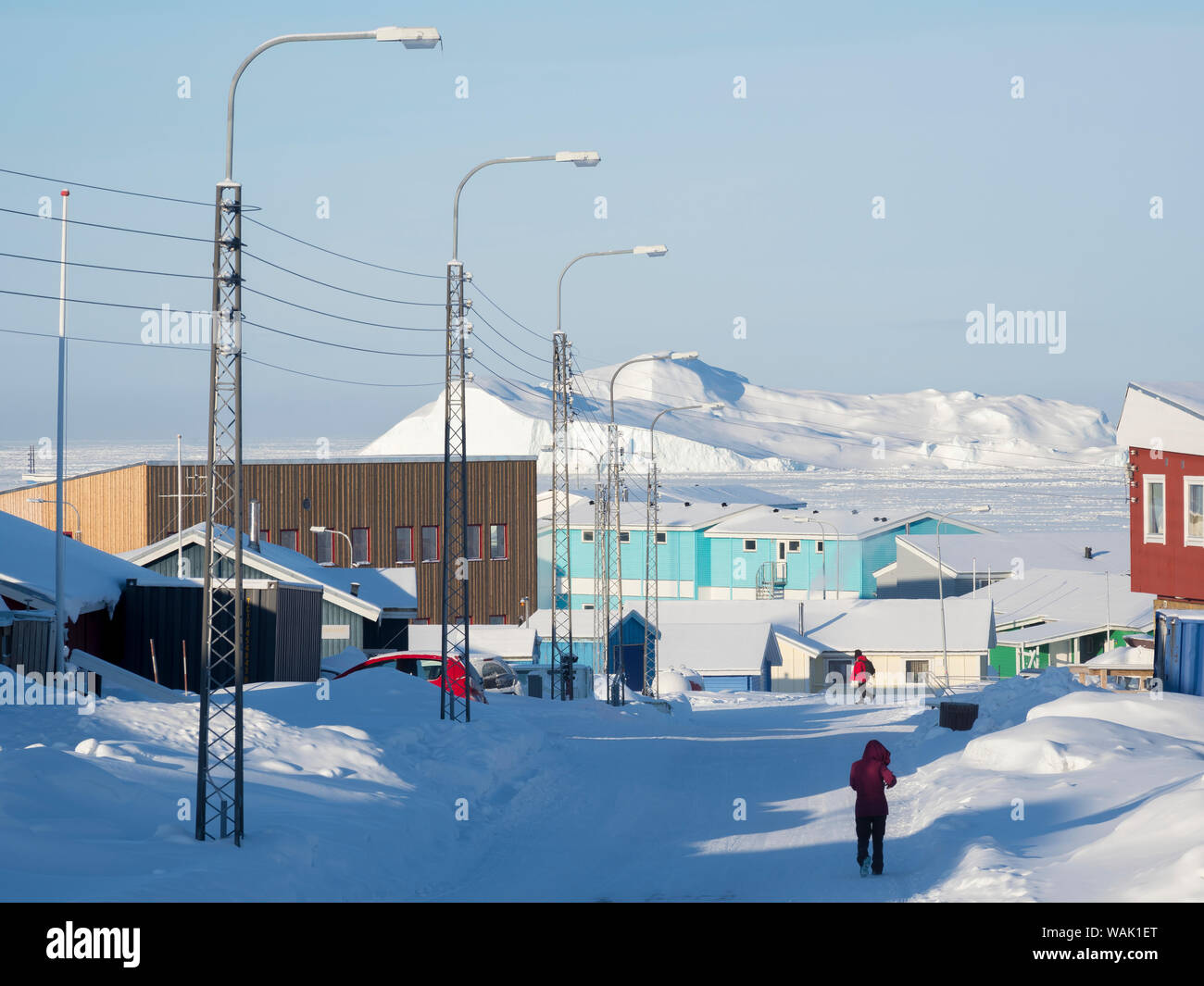 Streets in town, frozen Disko Bay with icebergs in the background. Greenland. (Editorial Use Only) Stock Photo