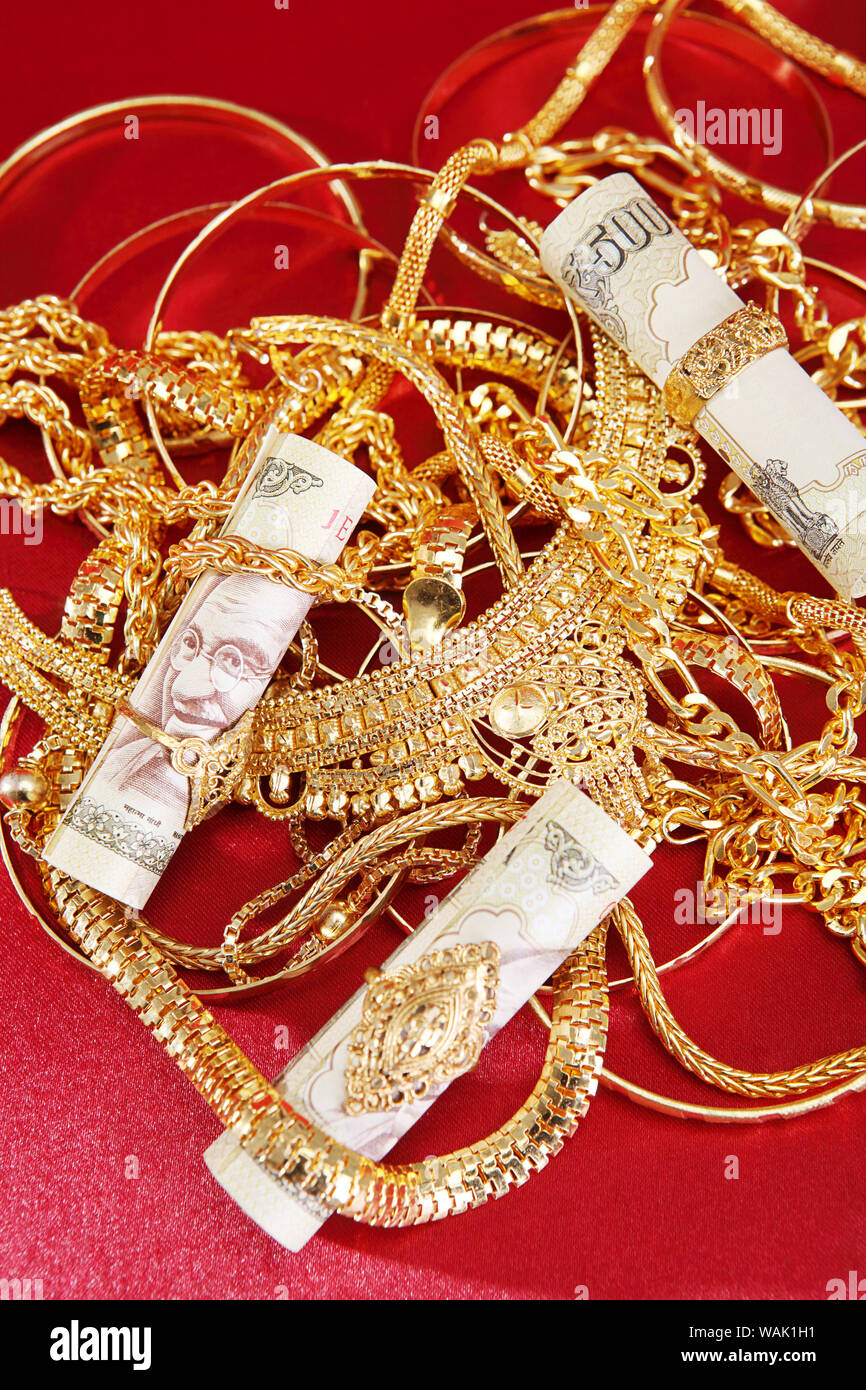 Jewelry with banknotes representing Gold Loan concept Stock Photo - Alamy