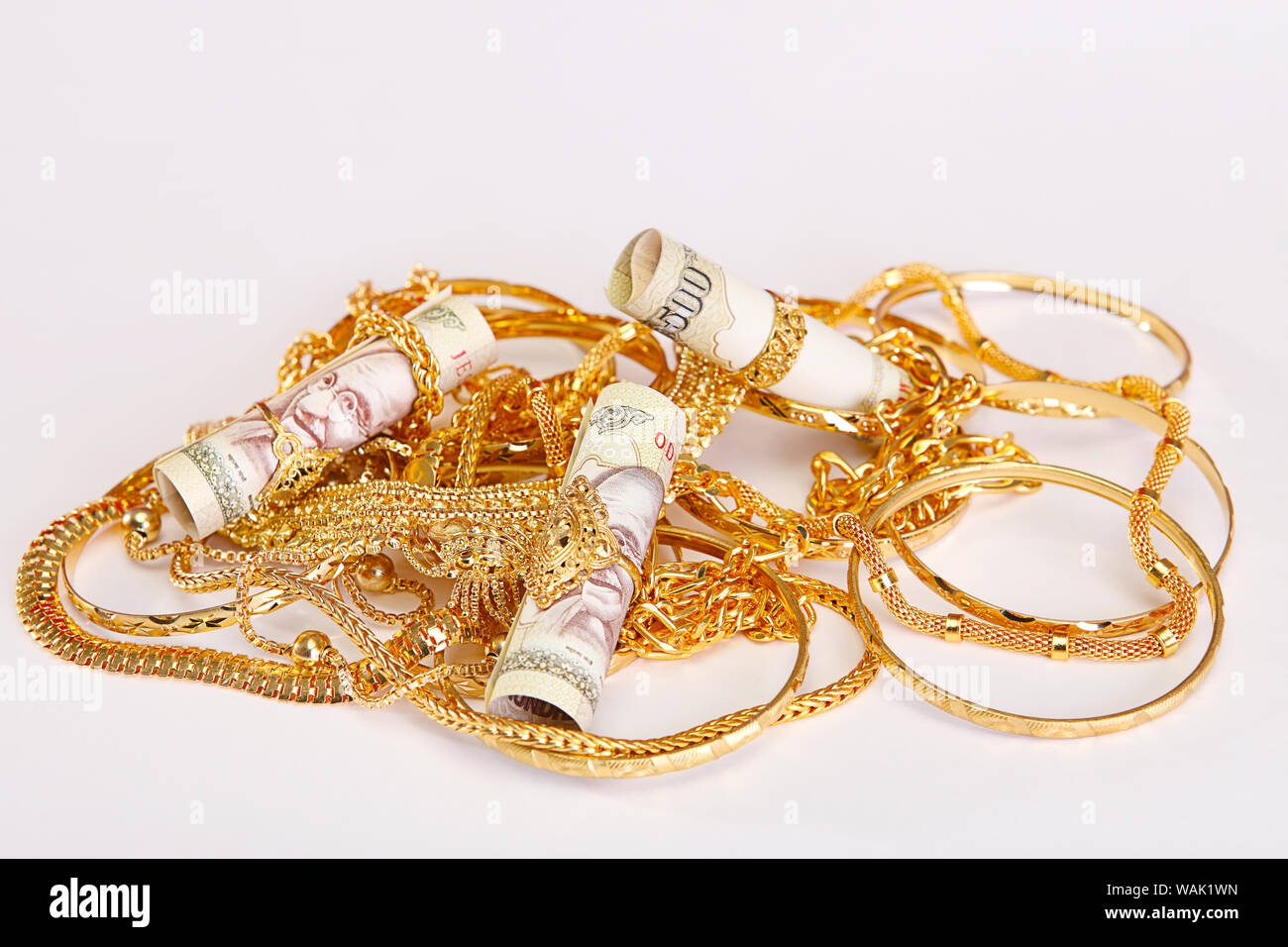 Jewelry with banknotes representing Gold Loan concept Stock Photo - Alamy