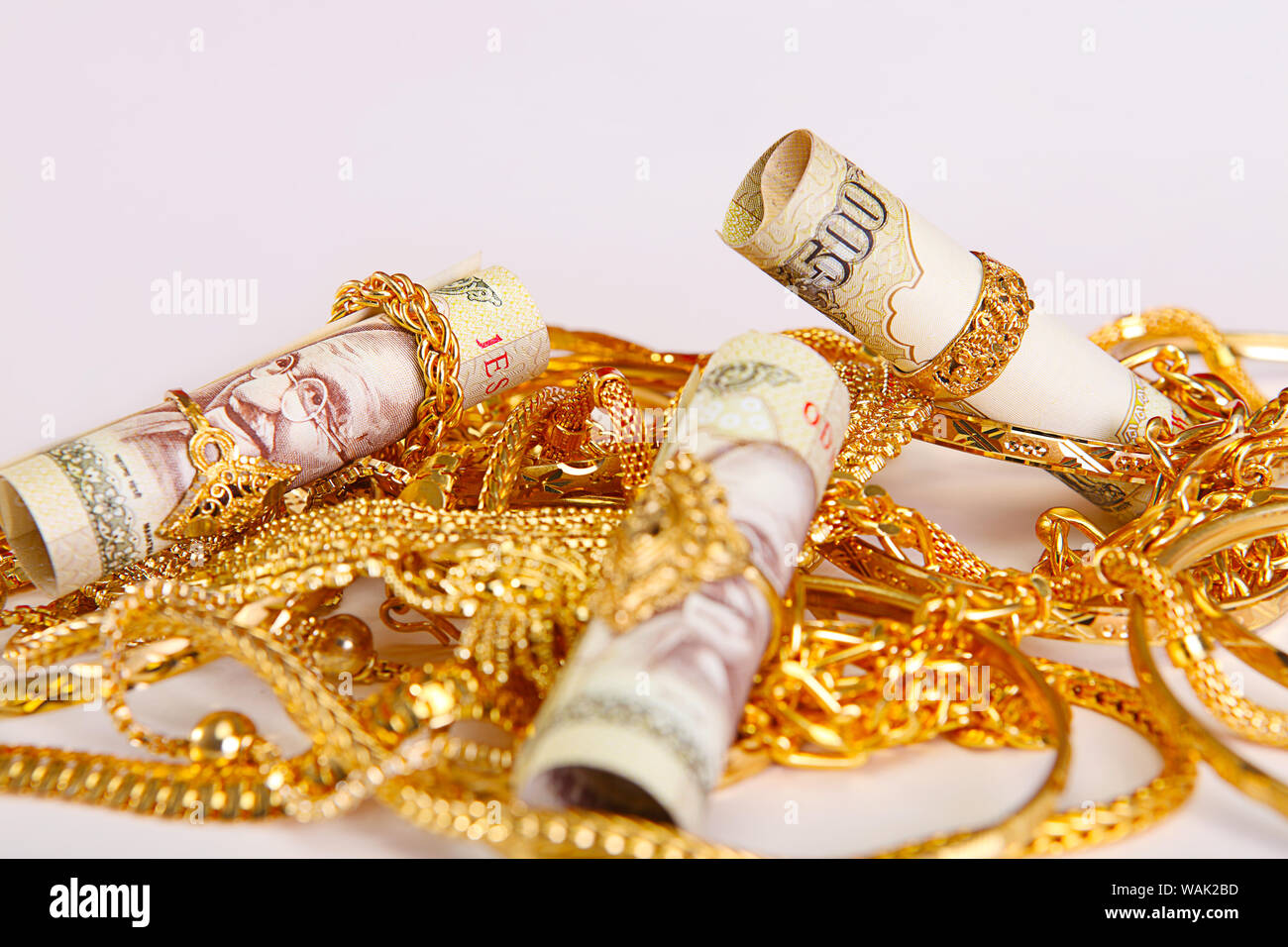 Jewelry with banknotes representing Gold Loan concept Stock Photo - Alamy