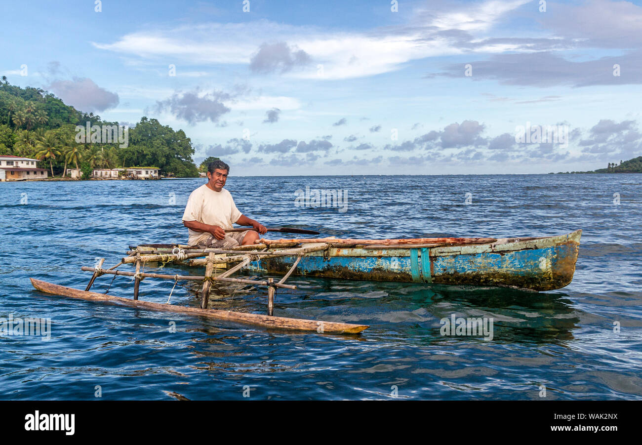 Kosrae, Micronesia (FSM). Man paddling his handcarved outrigger canoe
