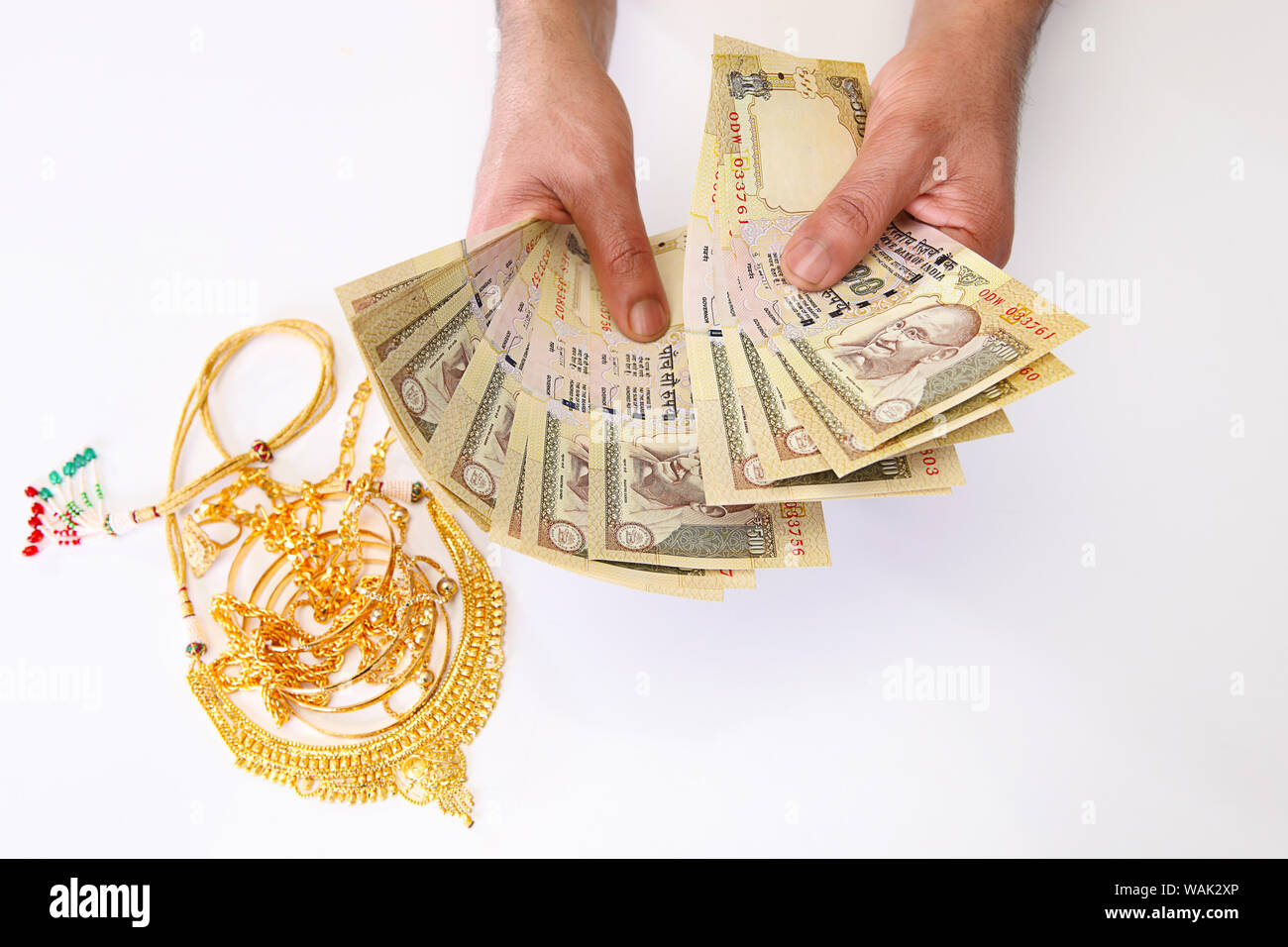 Jewelry with banknotes representing "Gold Loan" concept Stock Photo - Alamy