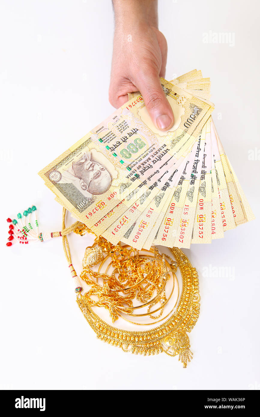 Jewelry with banknotes representing "Gold Loan" concept Stock Photo - Alamy