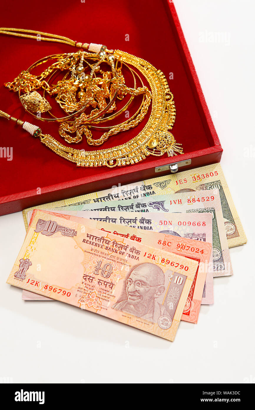 Jewelry with banknotes representing Gold Loan concept Stock Photo - Alamy