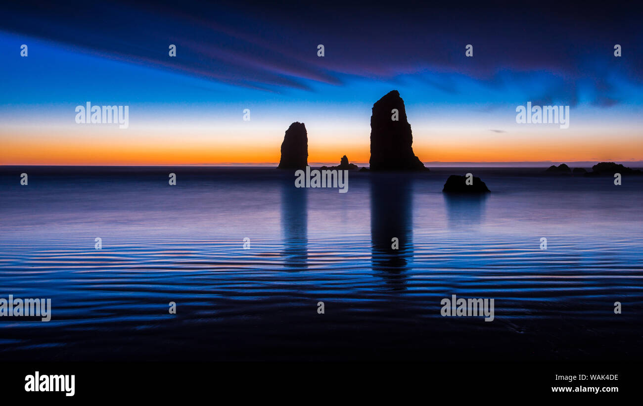 USA, Oregon, Cannon Beach, Seastack reflection at sunset. Stock Photo