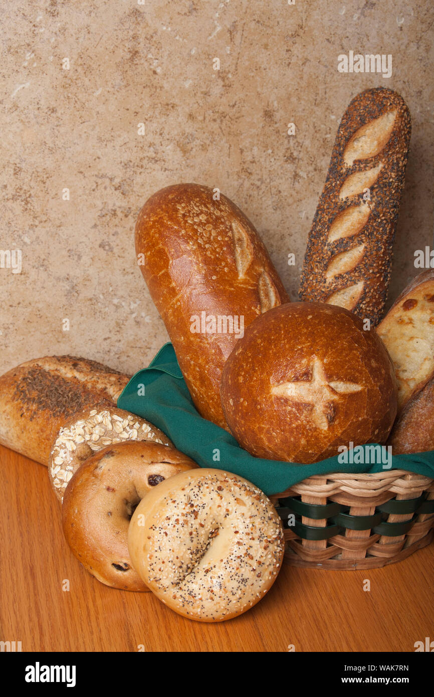 Variety of homemade breads. Sourdough bread bowl, sourdough loaf, three seed loaf, three cheese loaf, stone milled rye loaf, everything bagel, cinnamon swirl and raisin bagel and whole grain bagel Stock Photo
