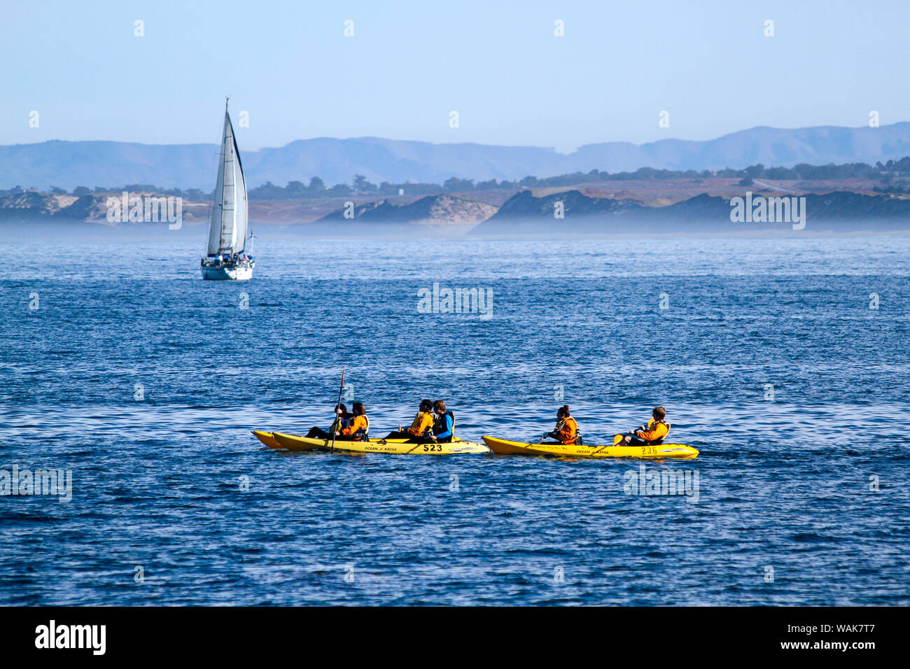 Kayaks and a sailboat near San Carlos Beach, Monterey, California, USA. Stock Photo