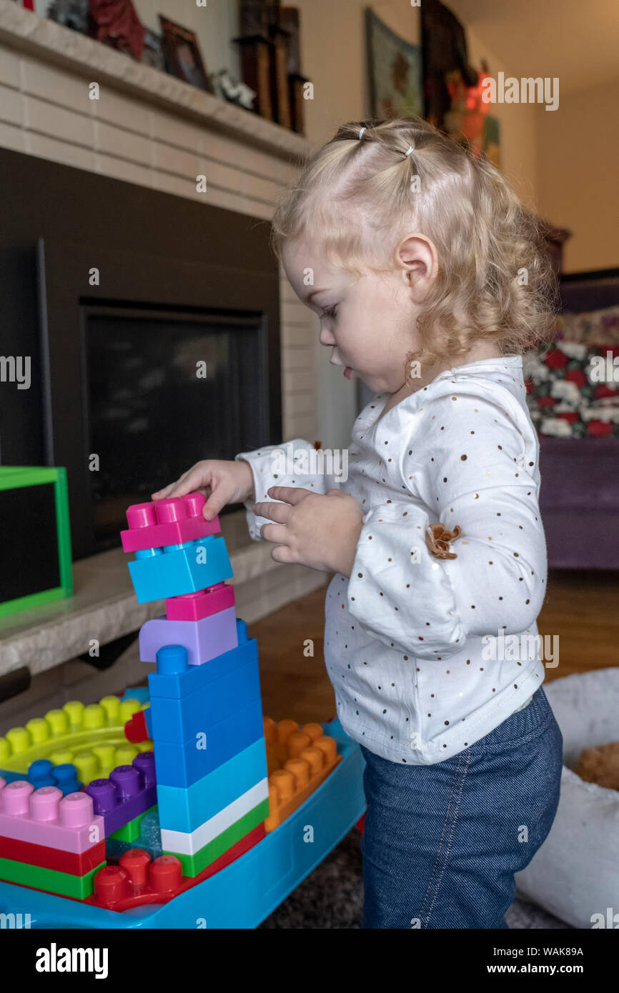 2 year old stacking blocks in a column. (MR,PR) Stock Photo