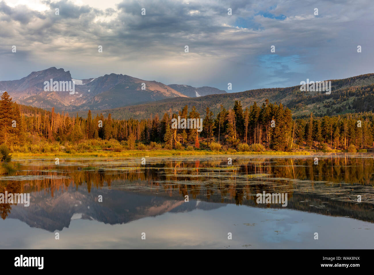 Sunrise light on Hallett Peak and Flattop Mountain above Sprague Lake in Rocky Mountain National Park, Colorado, USA Stock Photo