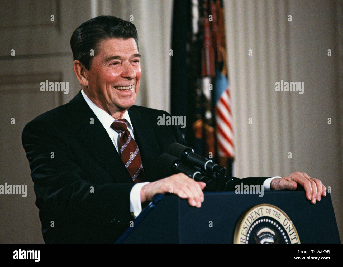 April 01, 1985. Washington, D.C. Reagan laughs at a question at a press conference in the East Room. Stock Photo