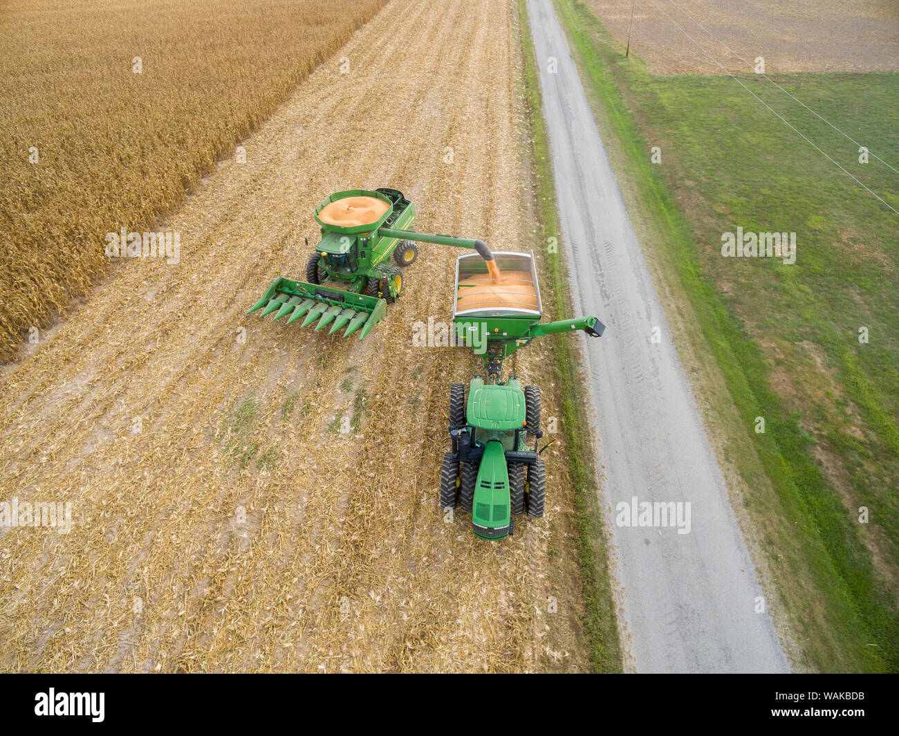 John Deere unloading corn into grain cart. Marion County, Illinois. Stock Photo