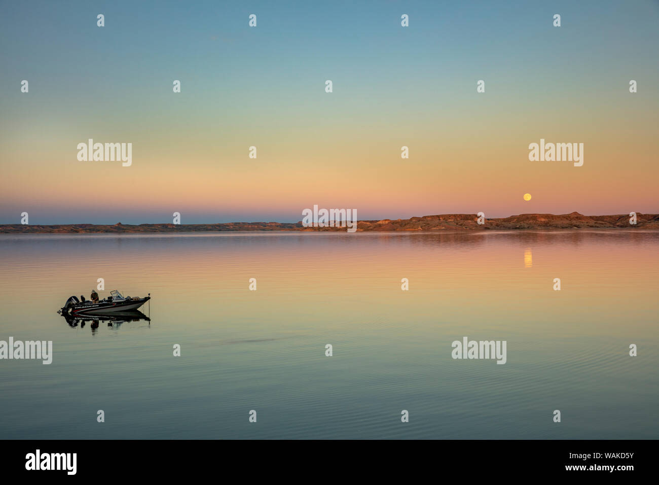 Fishing boat with full moonrise over Fort Peck Reservoir in the CM