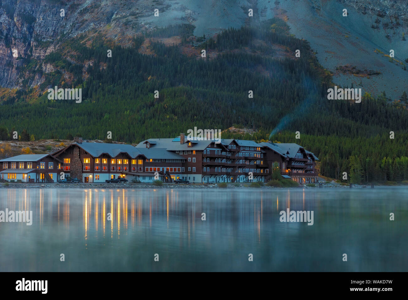 Many Glacier Lodge reflects into Swift current Lake at dawn in Glacier National Park, Montana, USA Stock Photo