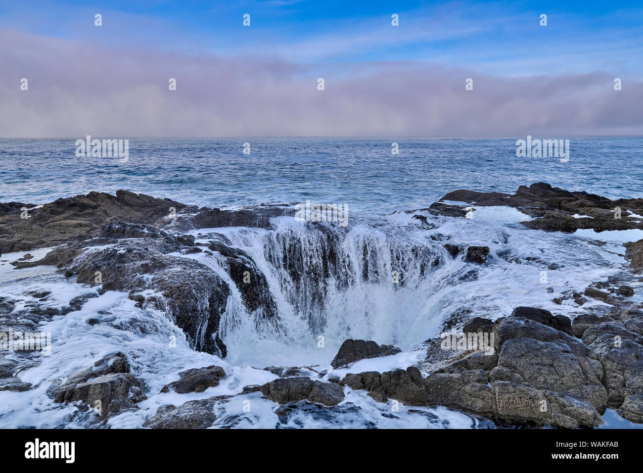 Thor's Well with surf cascading into the well along the Oregon coastline Stock Photo