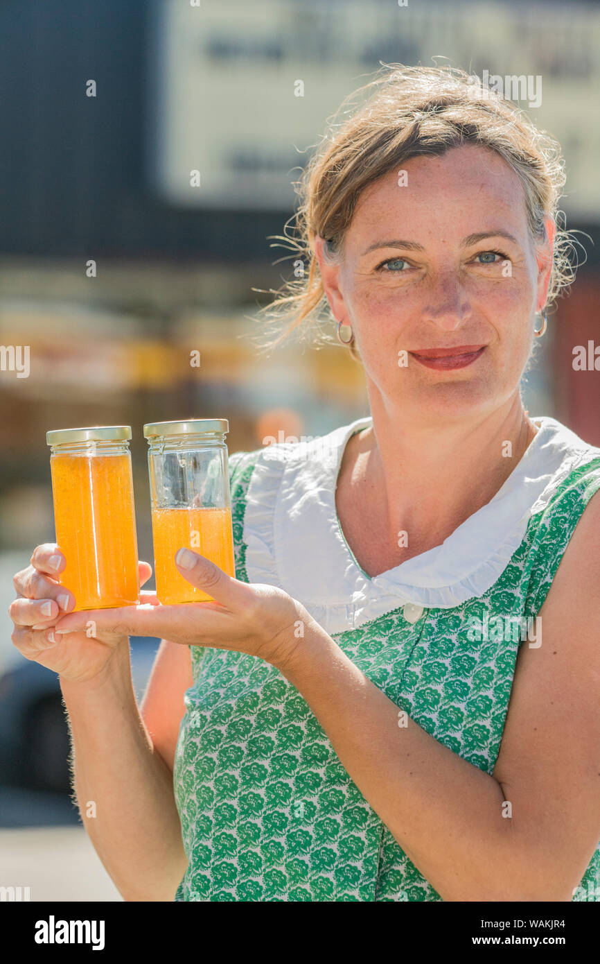 Woman holding jars of honey that were freshly extracted, strained and bottled. (MR) Stock Photo