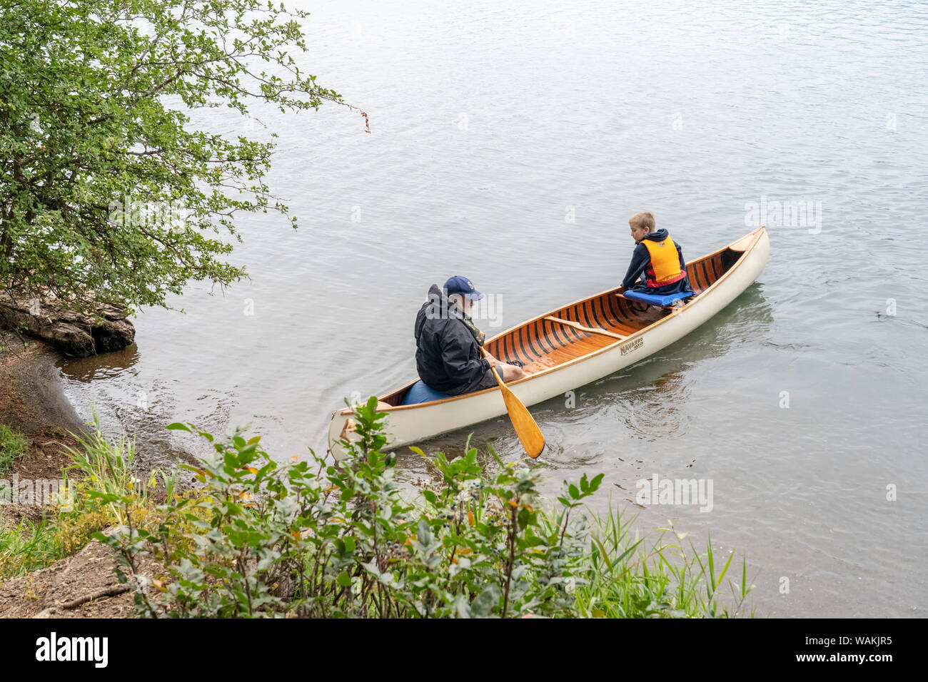 Lake Easton State Park, Washington State, USA. Grandfather and his 10 year old grandson on Lake Easton in a canoe. (MR) Stock Photo