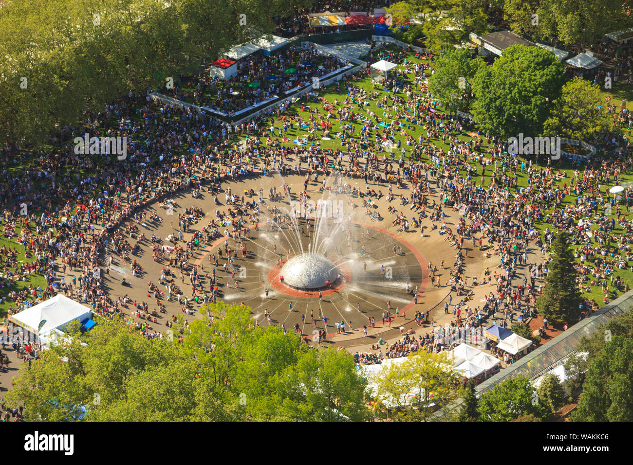 Music stage and food booths, crowds around Seattle Center Fountain