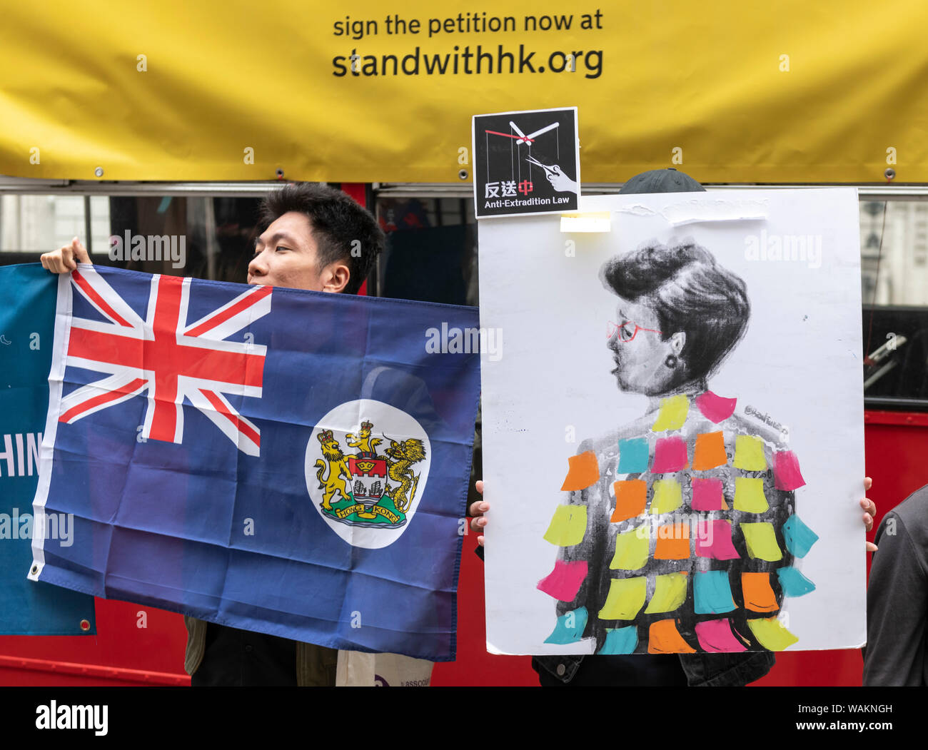 Protesters hold the Sino-British flag outside the Chinese Embassy in London.The protesters travelled round the city spreading the slogan Stand with Ho Stock Photo