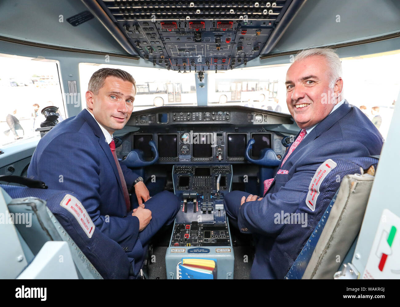 Schkeuditz, Germany. 21st Aug, 2019. Martin Dulig (l), Economics Minister of Saxony (SPD), and Dave Jackson, Head of 328 Support Services GmbH, are sitting in a Dornier 328 at Leipzig-Halle Airport. The US company Sierra Nevada Corporation (SNC) plans to build the aircraft with 39 seats in Leipzig in the future. Its predecessor, the DO 328, was developed in Oberpfaffenhofen in the 1980s. It was the last airplane developed in Germany. Credit: Jan Woitas/dpa-Zentralbild/dpa/Alamy Live News Stock Photo