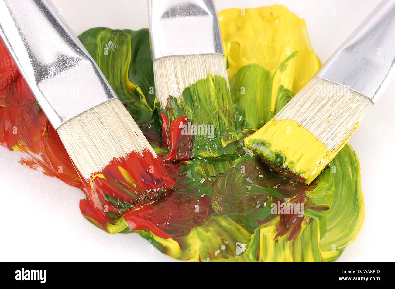 Paint and paintbrush on wet paint Stock Photo