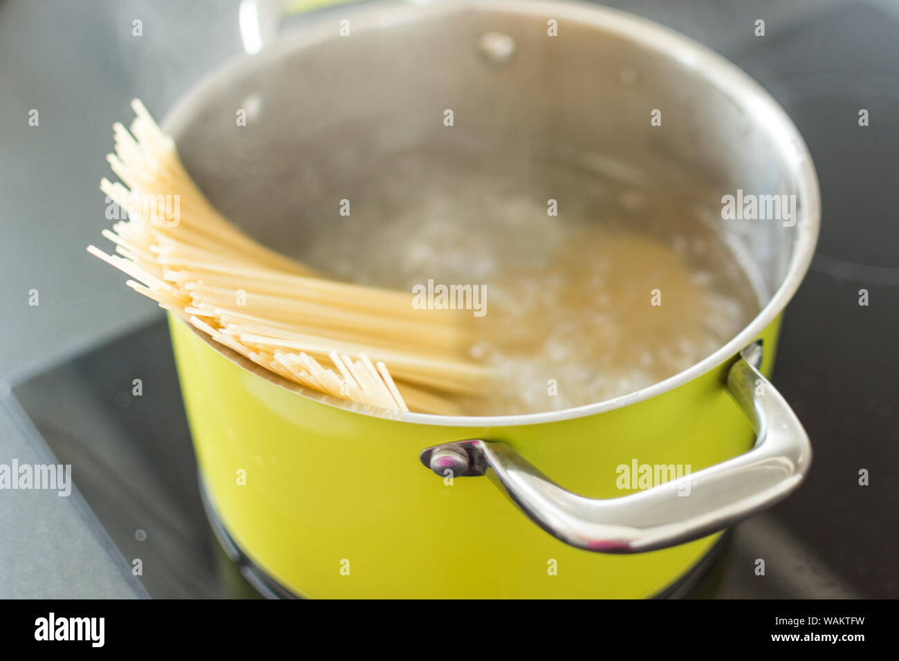 Spaghetti boiling in a saucepan on a stove. Cooking of noodles. Ilalian