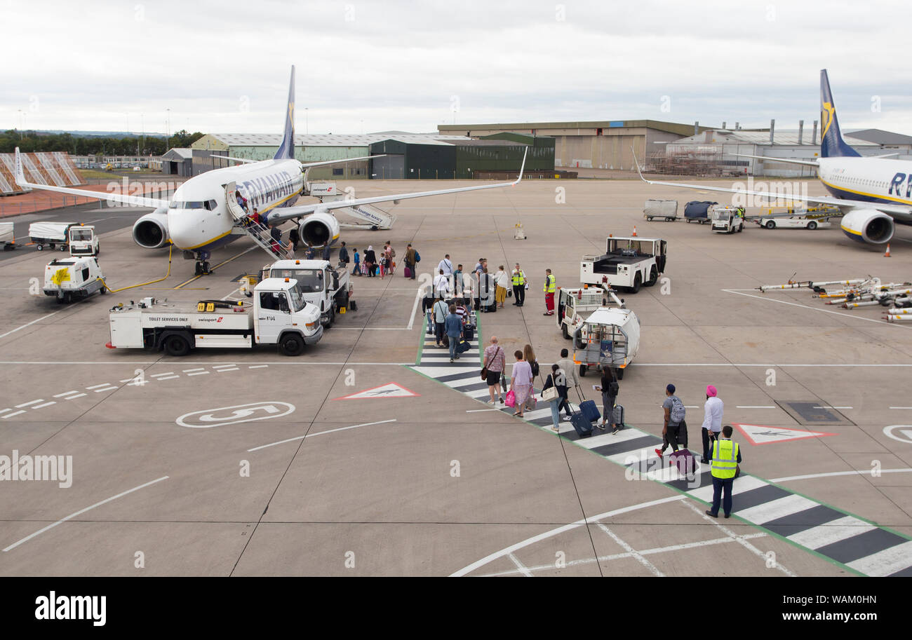 passengers boarding a ryanair flight in east midlands airport Stock