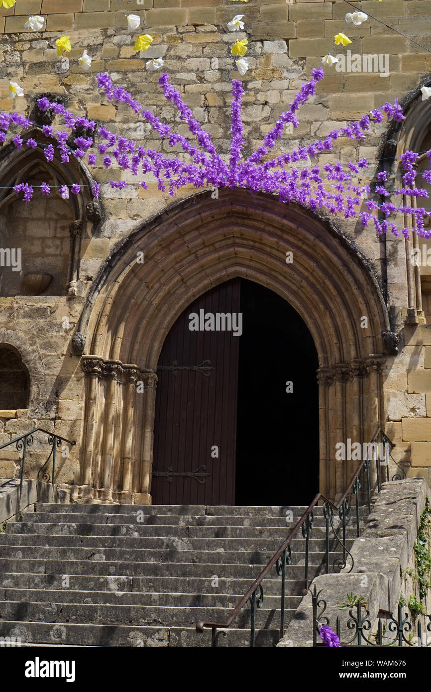 Door and archway of an old French Church with felibree festival decorations Stock Photo