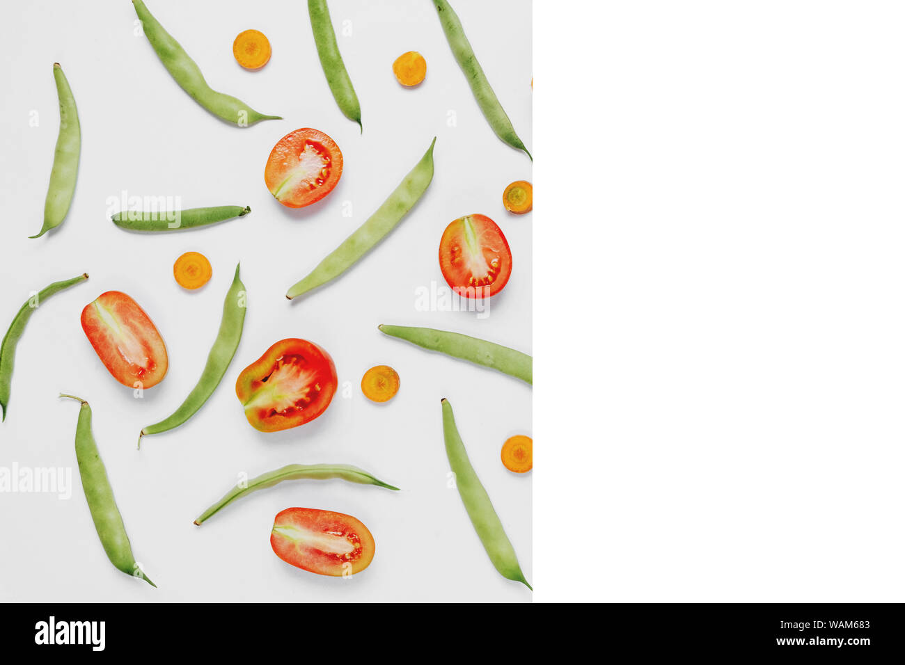 Pattern made of haricot, tomatoes, carrot on white background .Flat lay, top view, copy space. Food concept. Stock Photo