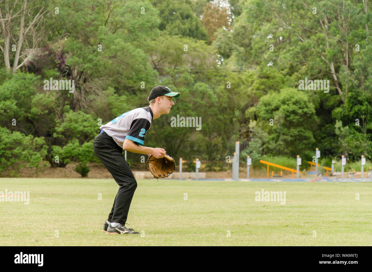 A young 18 year old Australian male baseball player at a Saturday game in Sydney, Australia Stock Photo