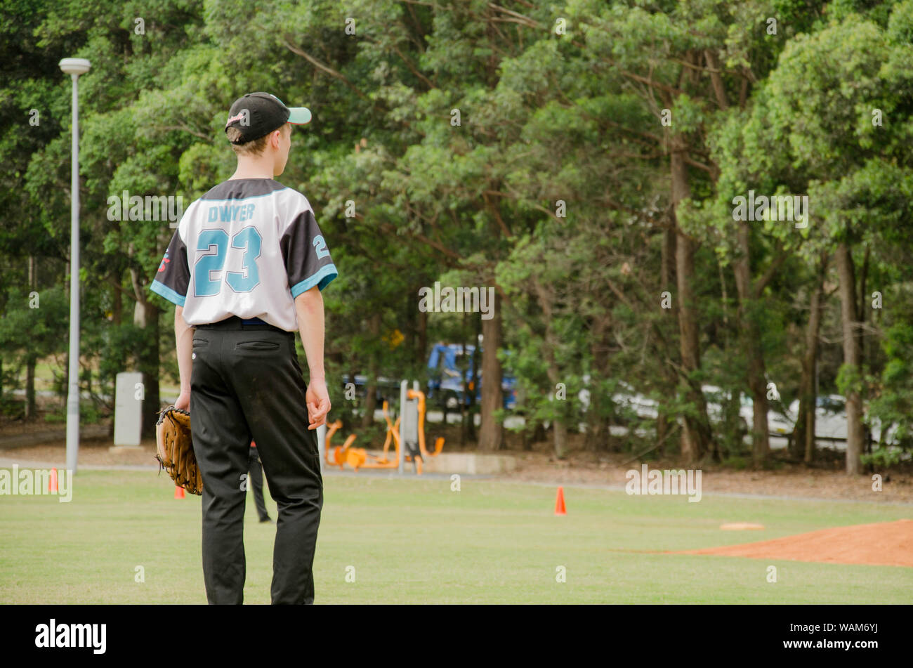 A young 18 year old Australian male baseball player at a Saturday game in Sydney, Australia Stock Photo