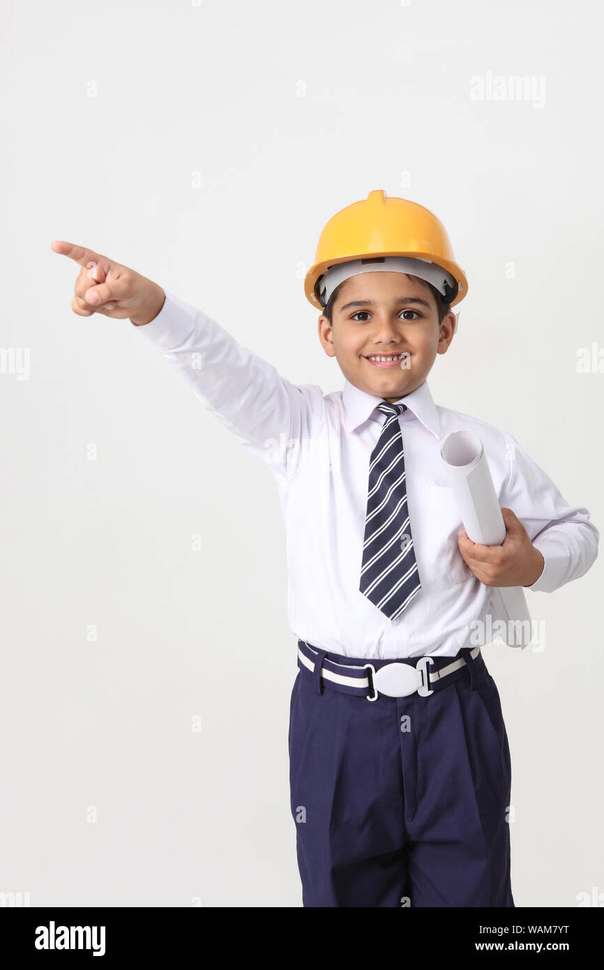 Boy pretending to be an architect and showing something Stock Photo Alamy