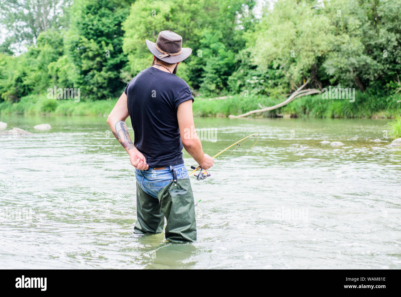 hobby and sport activity. pothunter. bearded fisher in water. summer  weekend. Big game fishing. fisherman with fishing rod. mature man fly  fishing. man catching fish. Deep Sea Fishing Stock Photo - Alamy