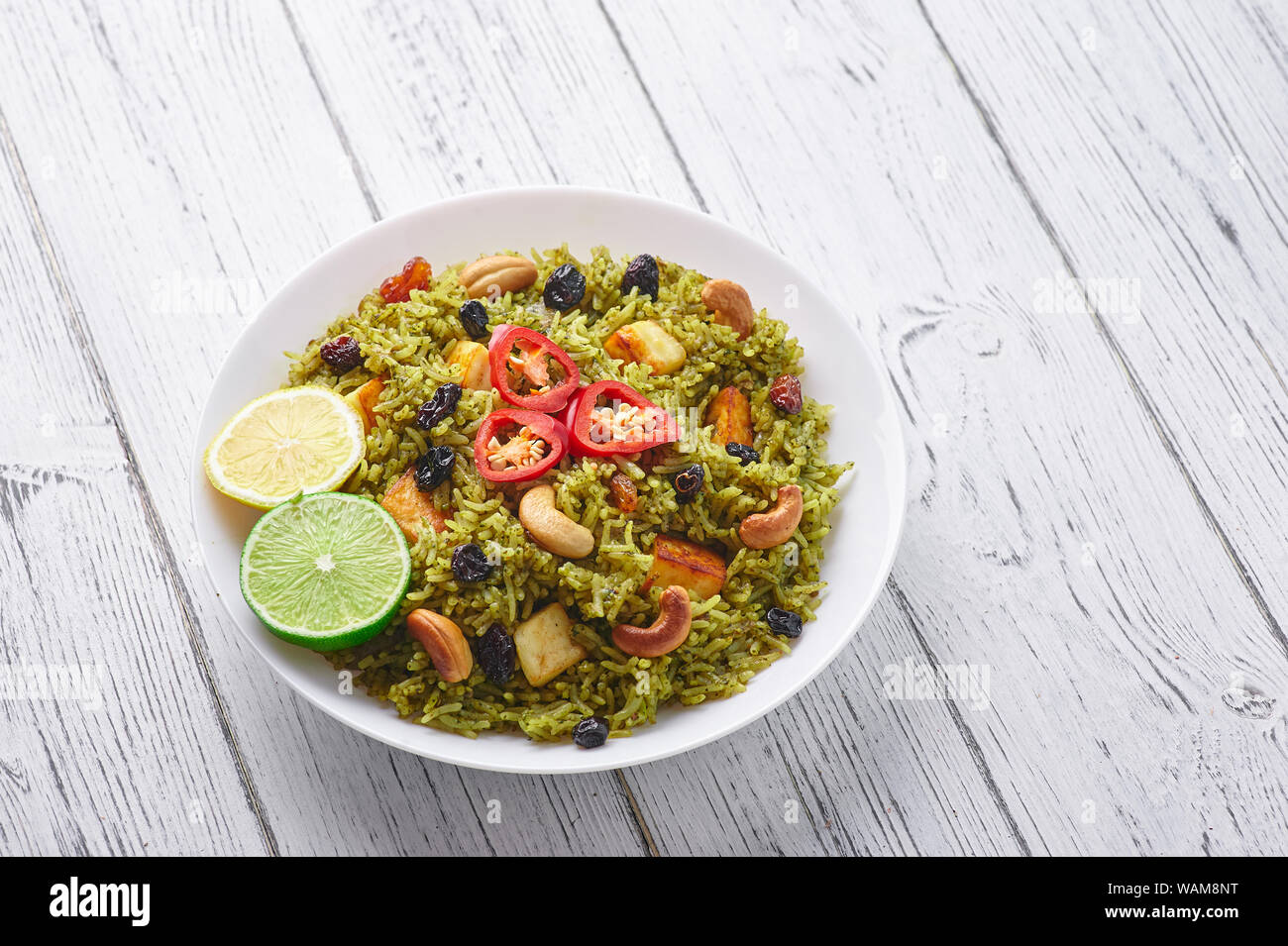 Palak Paneer Biryani at white wooden background. Palak Paneer Biryani