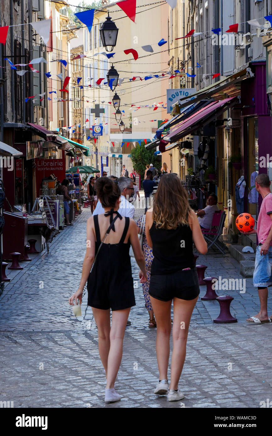 Rear view of two unidentified young girls walking in a street, Anduze,  Cévennes, Gard, France Stock Photo - Alamy