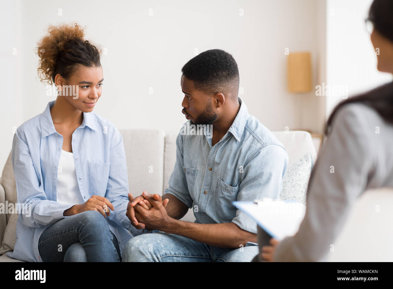 Afro Husband Making Up With Wife After Successful Therapy Session Stock Photo