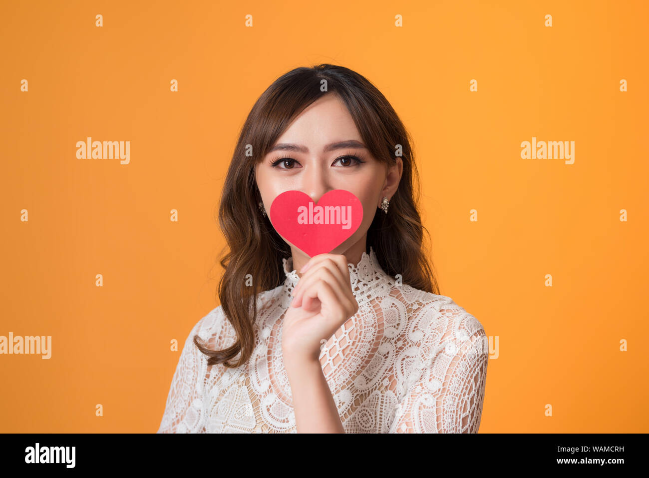 Portrait of young beautiful asian woman hands holding red heart shape ...