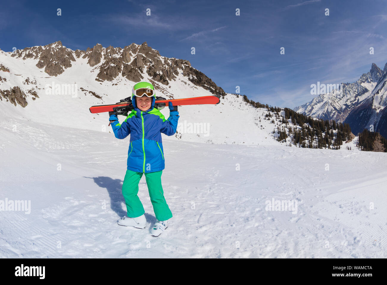 Portrait of happy boy on the slope hold ski Stock Photo - Alamy